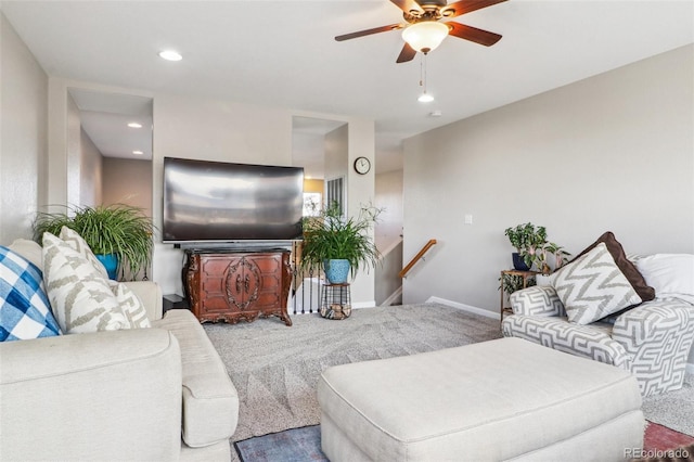 carpeted living room with ceiling fan, baseboards, and recessed lighting