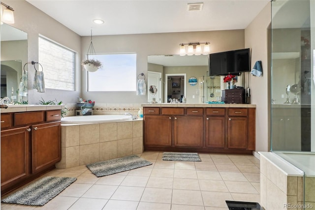 bathroom with visible vents, a shower with shower door, tile patterned flooring, vanity, and a bath