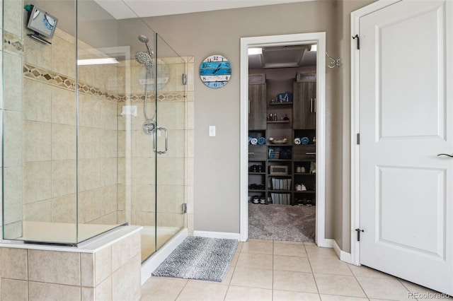 bathroom featuring baseboards, a shower stall, and tile patterned floors