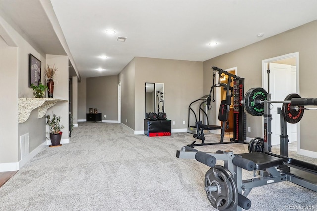 exercise area featuring visible vents, recessed lighting, light colored carpet, and baseboards