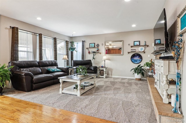 carpeted living area with baseboards and recessed lighting