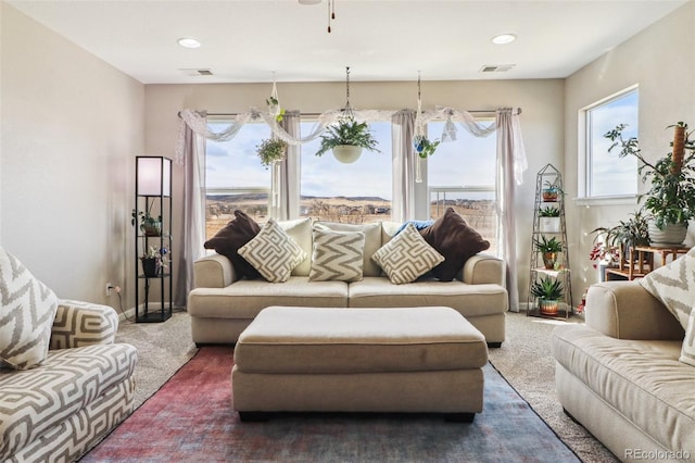 living area with carpet flooring and visible vents