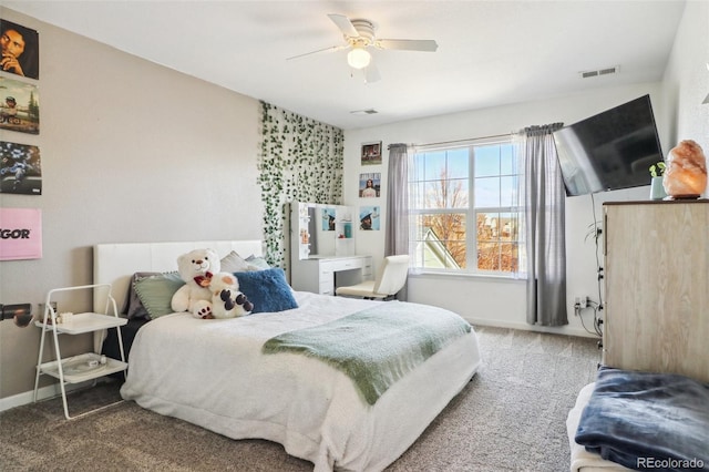 carpeted bedroom with visible vents, baseboards, and a ceiling fan
