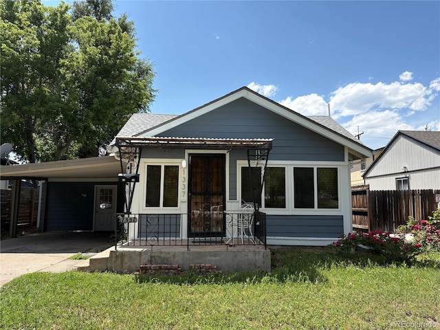 1337 Valentia St, Denver, CO 80220 - bungalow-style home with driveway, an attached carport, and a shingled roof