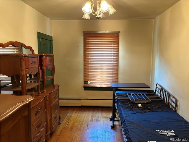 1337 Valentia St, Denver, CO 80220 - bedroom with wood-type flooring, a baseboard radiator, and a chandelier
