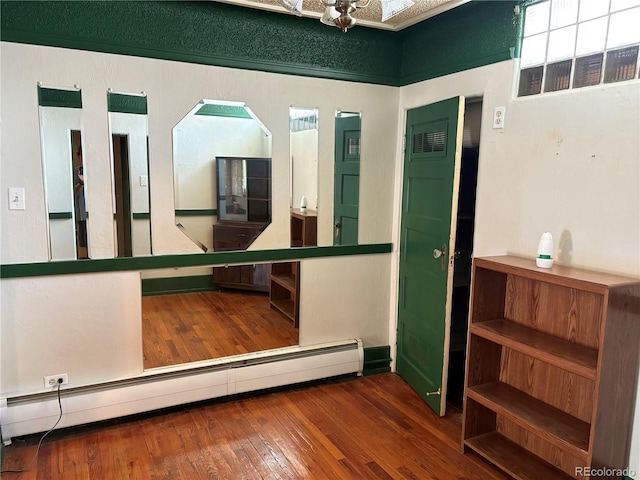1337 Valentia St, Denver, CO 80220 - unfurnished room featuring a baseboard radiator, hardwood / wood-style flooring, and arched walkways