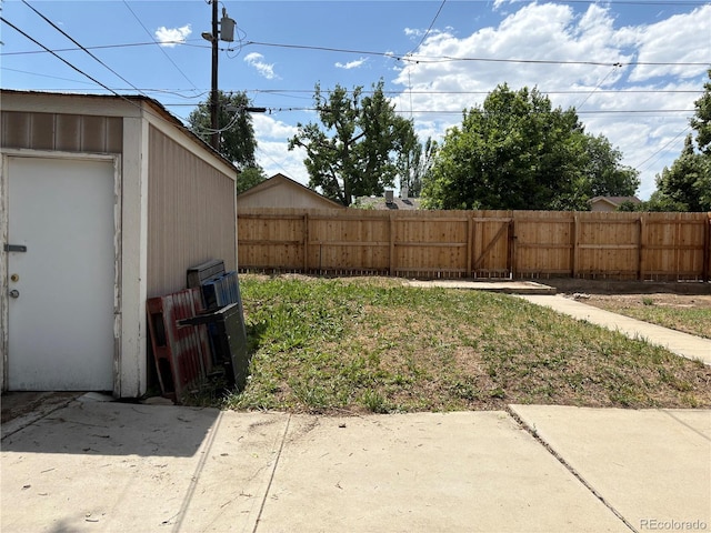 1337 Valentia St, Denver, CO 80220 - view of yard featuring a patio, a gate, and a storage unit