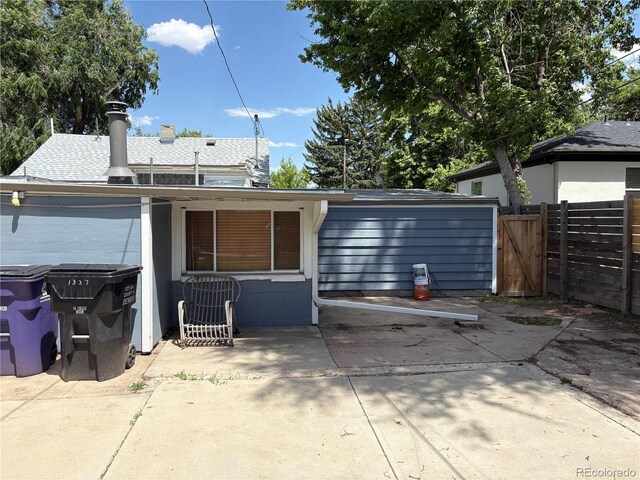 1337 Valentia St, Denver, CO 80220 - back of property with a patio, concrete block siding, and a gate