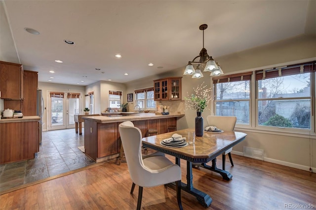 dining space featuring hardwood / wood-style floors and french doors