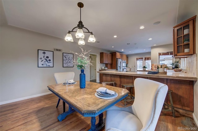 dining room featuring dark hardwood / wood-style flooring and an inviting chandelier