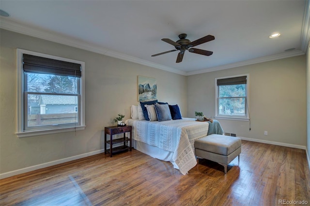 bedroom featuring ceiling fan, ornamental molding, and wood-type flooring