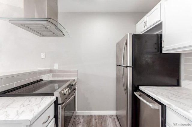 2267 S Buckley Rd Unit 202, Aurora, CO 80013 - kitchen featuring appliances with stainless steel finishes, exhaust hood, white cabinetry, light stone countertops, and light wood-style flooring