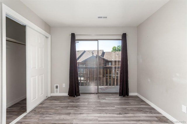 2267 S Buckley Rd Unit 202, Aurora, CO 80013 - unfurnished bedroom featuring wood finished floors and a closet