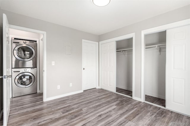 2267 S Buckley Rd Unit 202, Aurora, CO 80013 - washroom with estacked washer and dryer and wood finished floors