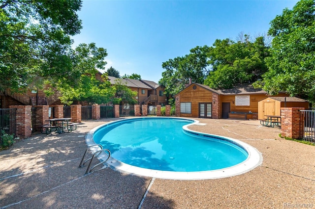 2267 S Buckley Rd Unit 202, Aurora, CO 80013 - community pool with a patio, french doors, and an outbuilding