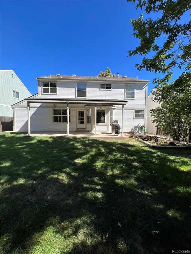 rear view of house with a yard, a patio area, and fence