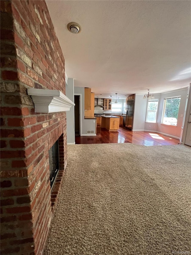 unfurnished living room with hardwood / wood-style flooring and a fireplace