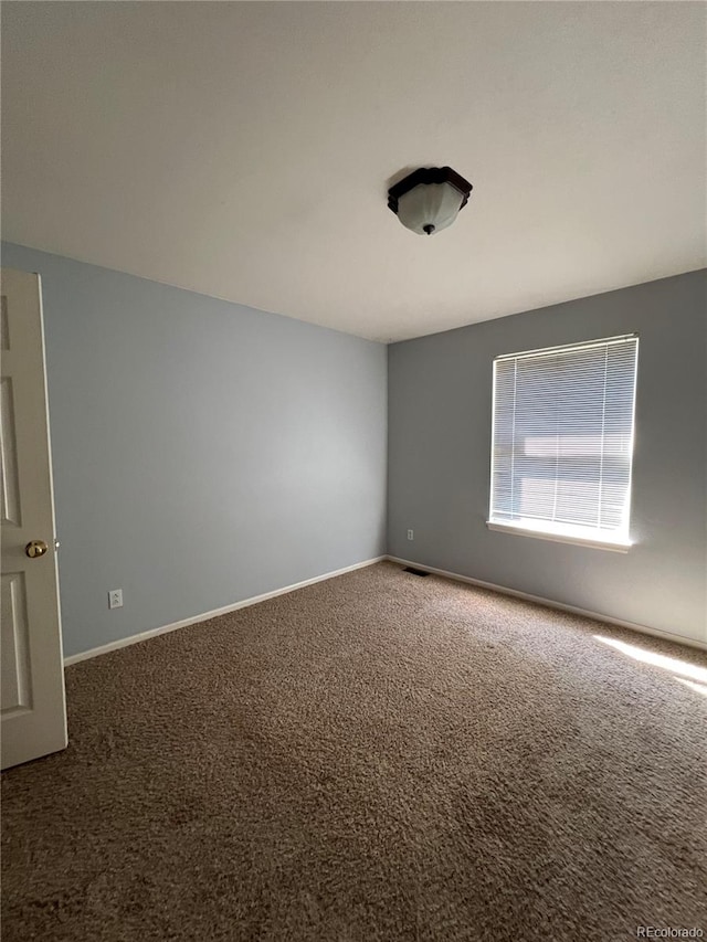 spare room featuring carpet flooring