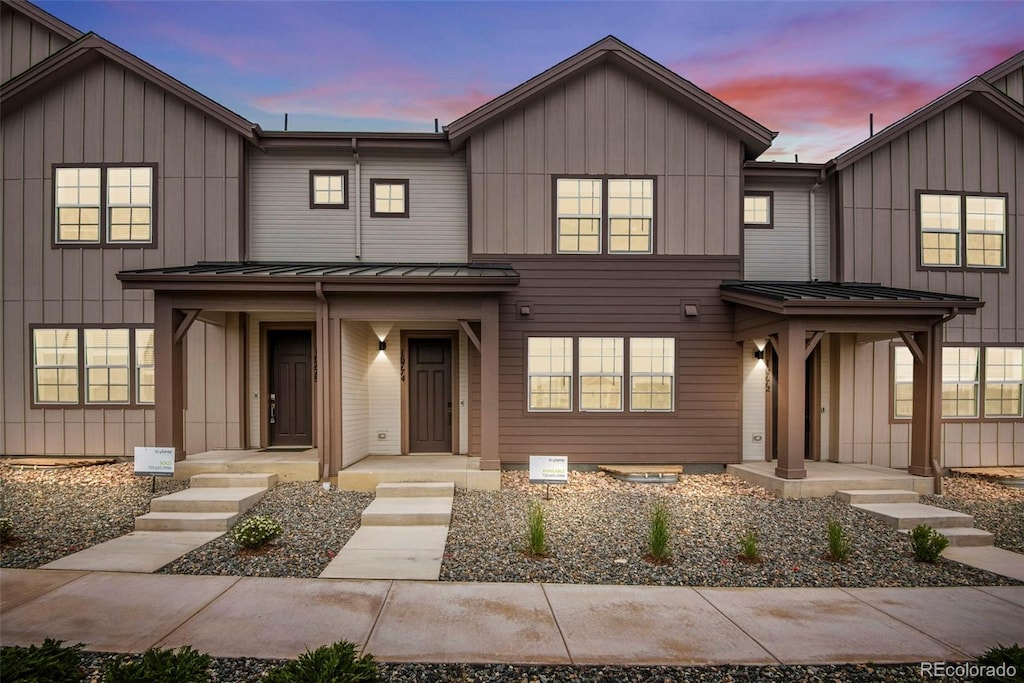 16774 W 93rd Pl, Arvada, CO 80007 - view of front of home with a standing seam roof, metal roof, and board and batten siding