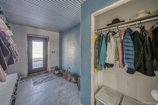 mudroom featuring concrete floors and a textured wall