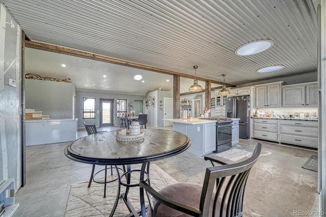 dining area with lofted ceiling, concrete floors, and recessed lighting