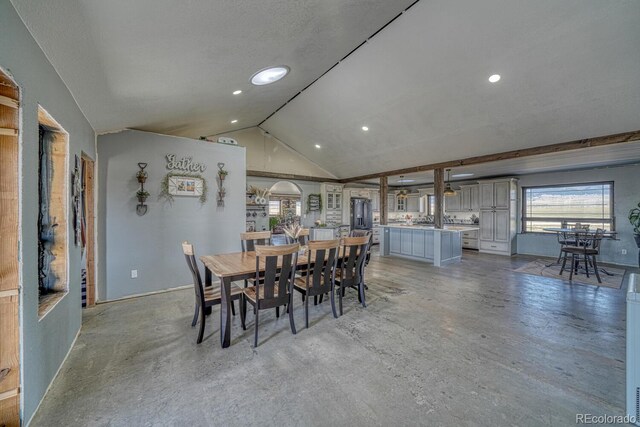 dining space with baseboards, concrete floors, vaulted ceiling, and recessed lighting