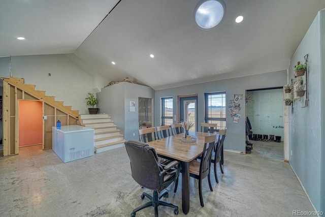 dining space with unfinished concrete flooring, lofted ceiling, stairway, and recessed lighting