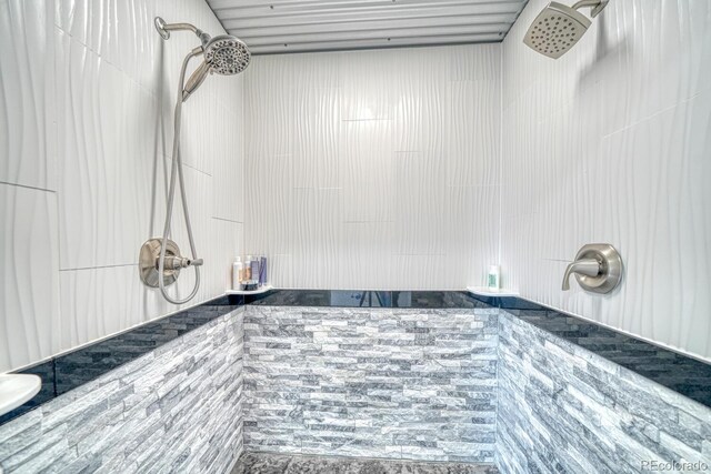 full bath with a tile shower