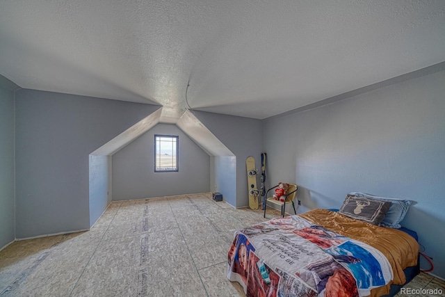 bedroom with vaulted ceiling and a textured ceiling