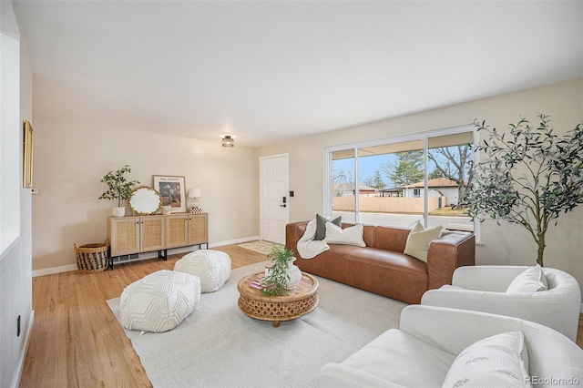 living room featuring wood finished floors and baseboards