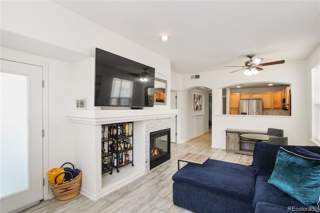 living room with ceiling fan and light hardwood / wood-style flooring