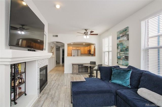 living room with hardwood / wood-style flooring and ceiling fan