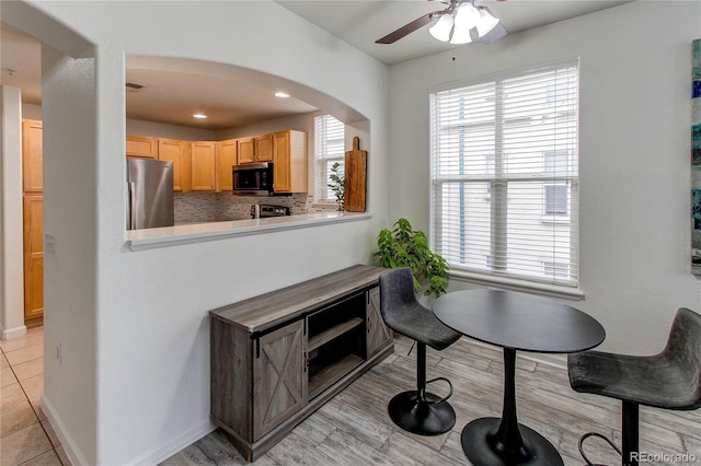 dining space with light tile patterned flooring and ceiling fan