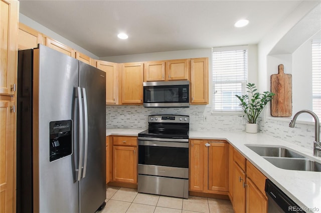 kitchen with sink, backsplash, stainless steel appliances, and light tile patterned flooring