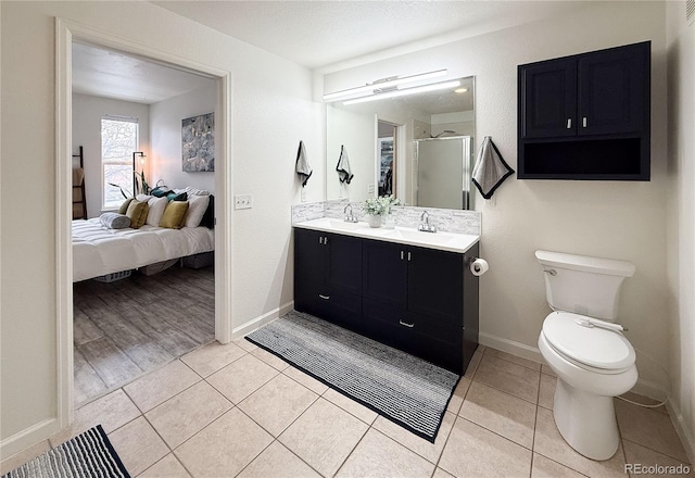 bathroom with toilet, a textured ceiling, vanity, a shower with door, and tile patterned flooring