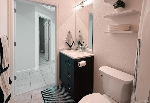 bathroom featuring tile patterned flooring, vanity, and toilet