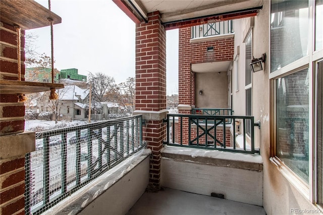 view of snow covered back of property