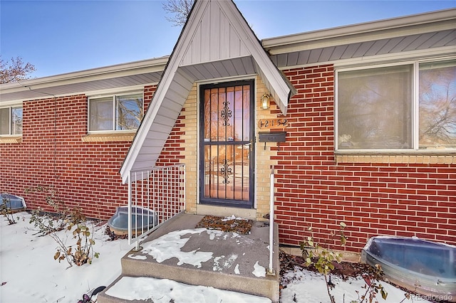 view of snow covered property entrance