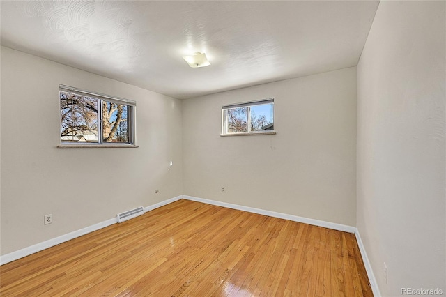 unfurnished room with light hardwood / wood-style flooring