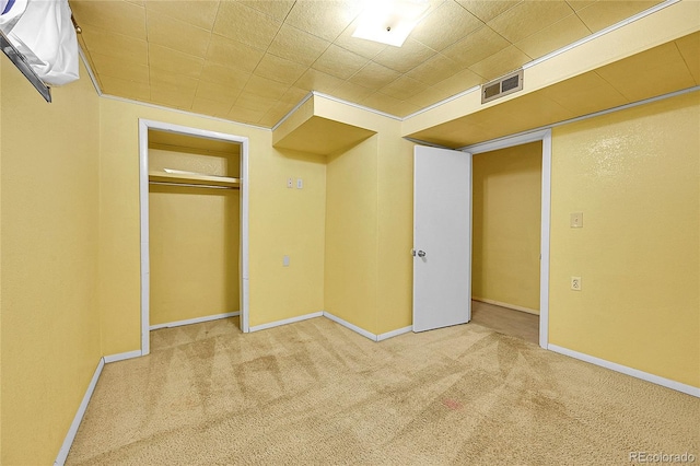 unfurnished bedroom featuring carpet floors and a closet