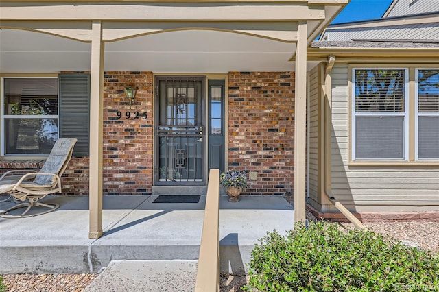 9925 W Progress Pl, Littleton, CO 80123 - property entrance with brick siding and a porch