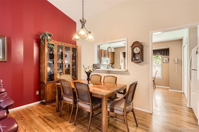 9925 W Progress Pl, Littleton, CO 80123 - dining space with light wood-type flooring, baseboards, and high vaulted ceiling
