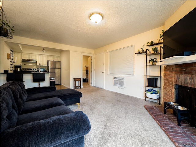 14590 E 2nd Ave Unit 105B, Aurora, CO 80011 - carpeted living room with a textured ceiling, a brick fireplace, and a wall unit AC