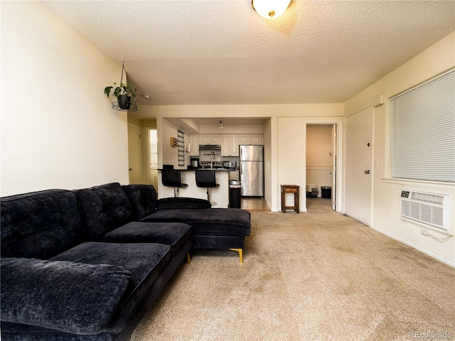 14590 E 2nd Ave Unit 105B, Aurora, CO 80011 - living area with light colored carpet, a wall mounted AC, and a textured ceiling