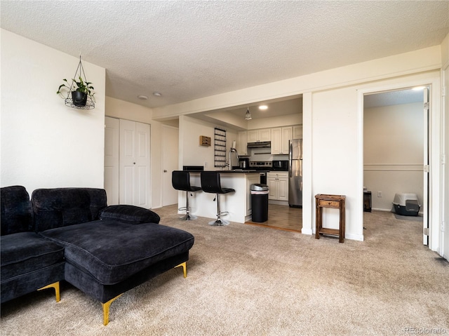 14590 E 2nd Ave Unit 105B, Aurora, CO 80011 - living area with light carpet and a textured ceiling