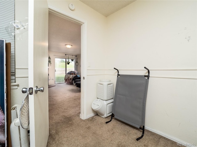 14590 E 2nd Ave Unit 105B, Aurora, CO 80011 - hallway featuring carpet flooring and a textured ceiling
