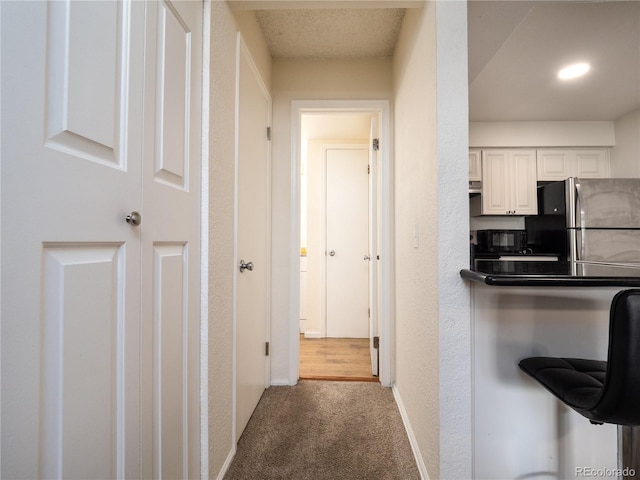 14590 E 2nd Ave Unit 105B, Aurora, CO 80011 - hall with carpet and a textured wall
