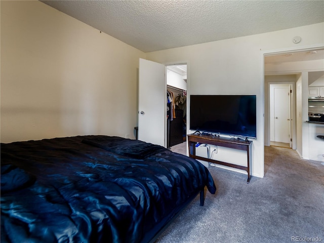 14590 E 2nd Ave Unit 105B, Aurora, CO 80011 - bedroom with carpet flooring and a spacious closet