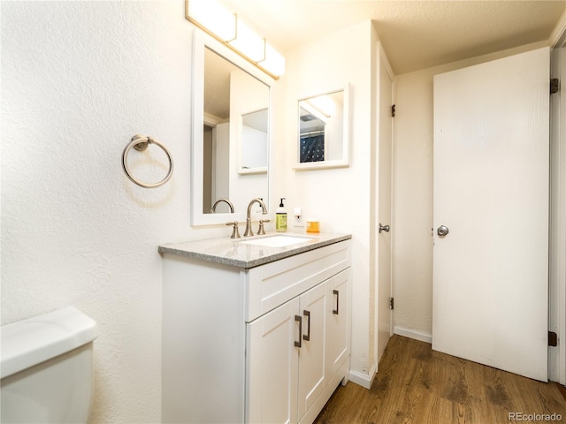 14590 E 2nd Ave Unit 105B, Aurora, CO 80011 - half bath featuring wood finished floors and vanity