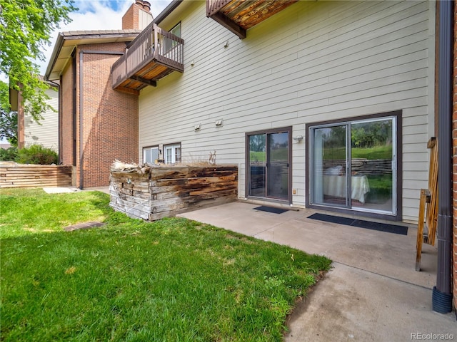 14590 E 2nd Ave Unit 105B, Aurora, CO 80011 - back of house with a balcony, a yard, and a patio